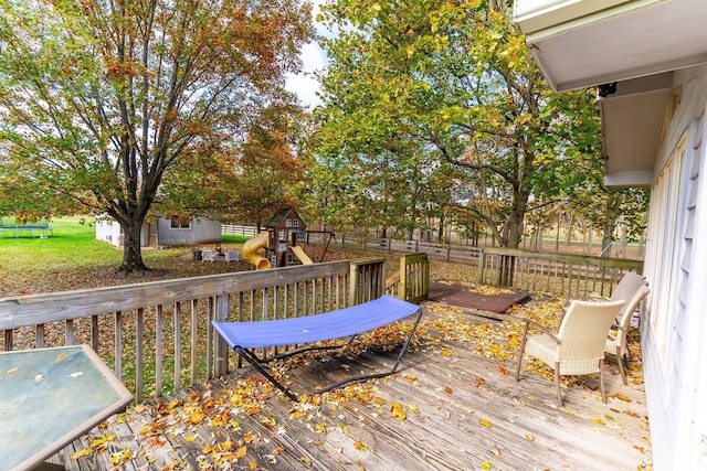 wooden deck featuring a playground