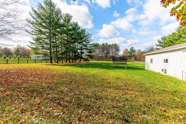 view of yard with a rural view and a trampoline