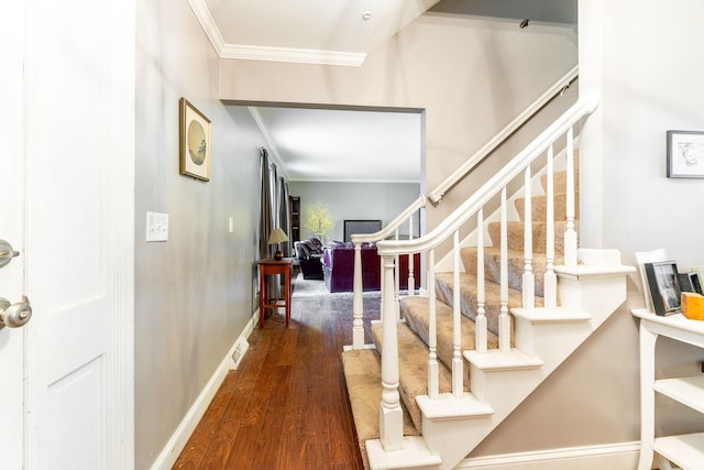 foyer featuring dark hardwood / wood-style floors and ornamental molding