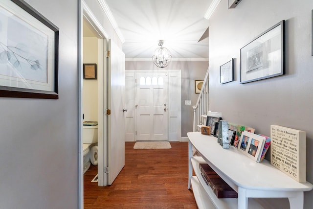 interior space with a chandelier, dark hardwood / wood-style floors, and ornamental molding