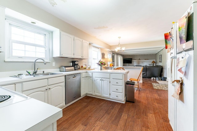 kitchen with stainless steel dishwasher, pendant lighting, white cabinets, and kitchen peninsula