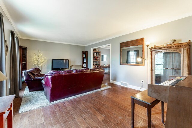 living room with crown molding and wood-type flooring