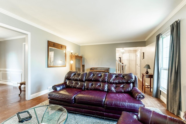 living room featuring light wood-type flooring and ornamental molding