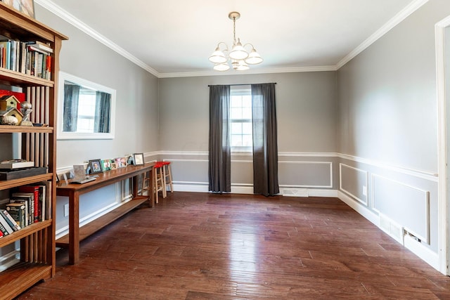 unfurnished room with a notable chandelier, ornamental molding, and dark wood-type flooring