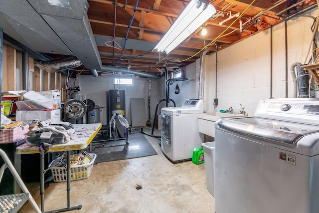 washroom with sink, water heater, and washing machine and clothes dryer