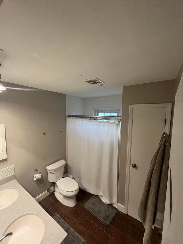 bathroom with a shower with shower curtain, vanity, toilet, and wood-type flooring