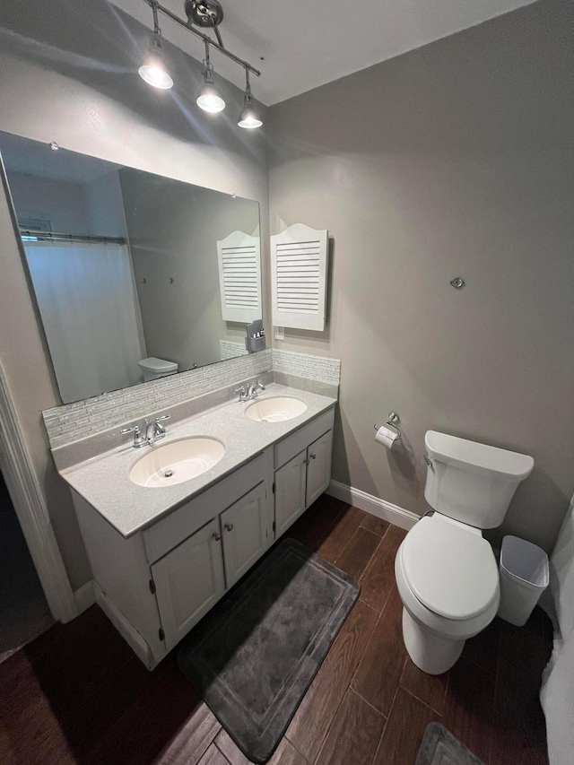 bathroom featuring hardwood / wood-style floors, vanity, and toilet