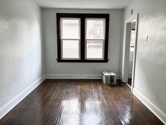 spare room featuring dark hardwood / wood-style floors