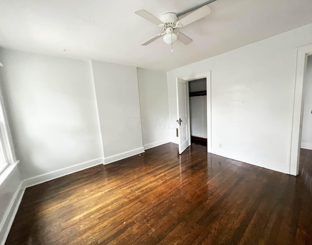 spare room featuring ceiling fan and dark wood-type flooring