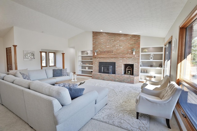 living room with a fireplace, a textured ceiling, a wealth of natural light, and built in shelves