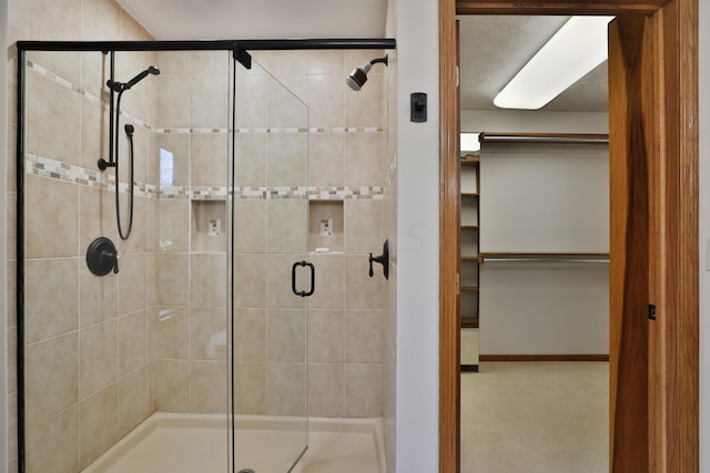 bathroom with a shower with door