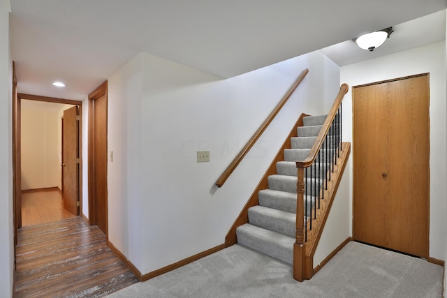 staircase with hardwood / wood-style flooring