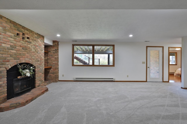 unfurnished living room with a fireplace, carpet, a baseboard radiator, and a textured ceiling