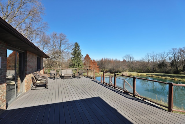 wooden deck featuring outdoor lounge area and a water view