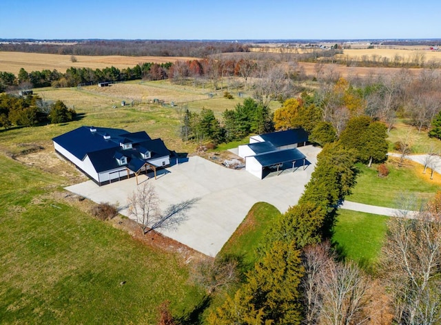 birds eye view of property with a rural view