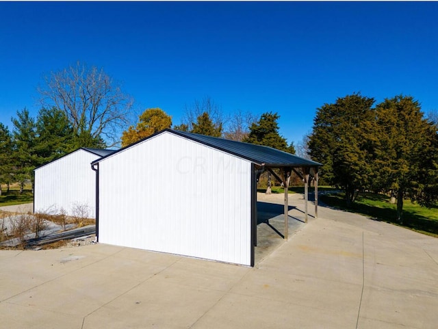 view of outbuilding with a carport