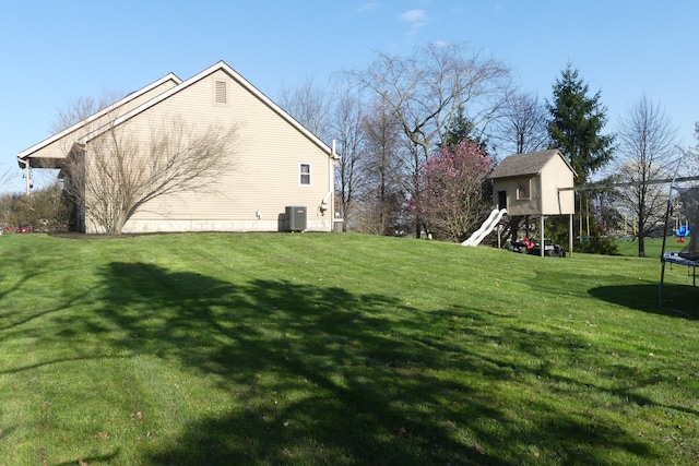 view of yard featuring cooling unit and a trampoline