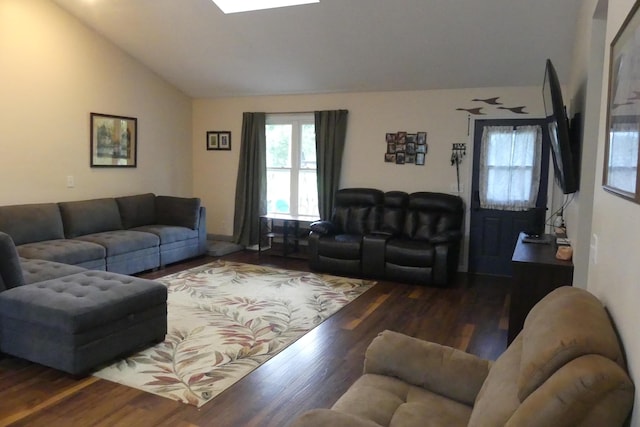 living room featuring dark hardwood / wood-style floors and vaulted ceiling