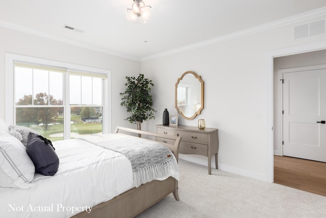 bedroom with light hardwood / wood-style floors and ornamental molding