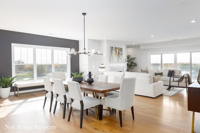 dining area with a notable chandelier and light wood-type flooring