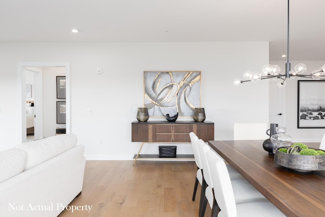 dining room featuring light hardwood / wood-style floors and a notable chandelier