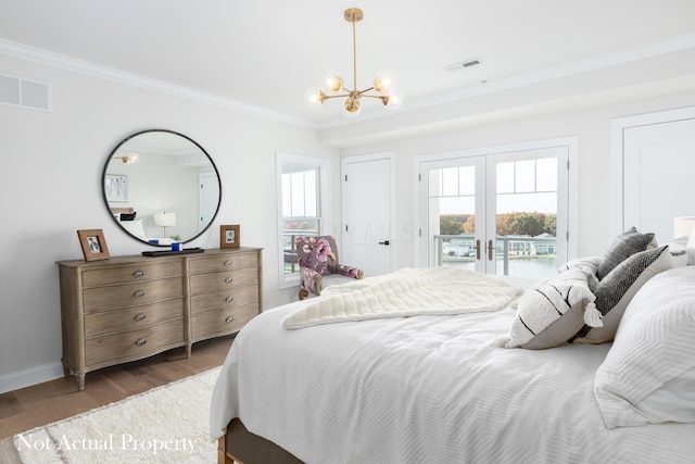 bedroom featuring french doors, dark hardwood / wood-style floors, access to exterior, ornamental molding, and a notable chandelier