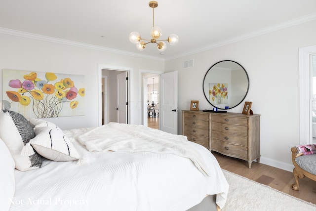 bedroom with light hardwood / wood-style floors, ornamental molding, and a chandelier