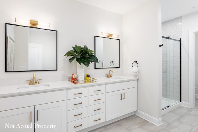 bathroom with tile patterned floors, vanity, and a shower with shower door