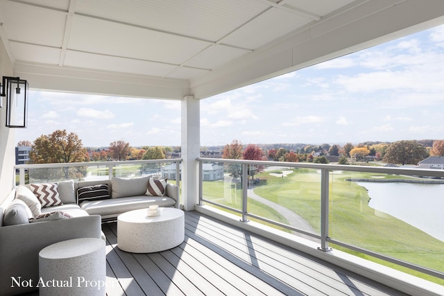 balcony with an outdoor living space and a water view