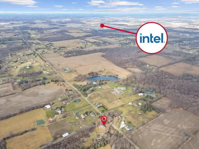 birds eye view of property with a water view and a rural view