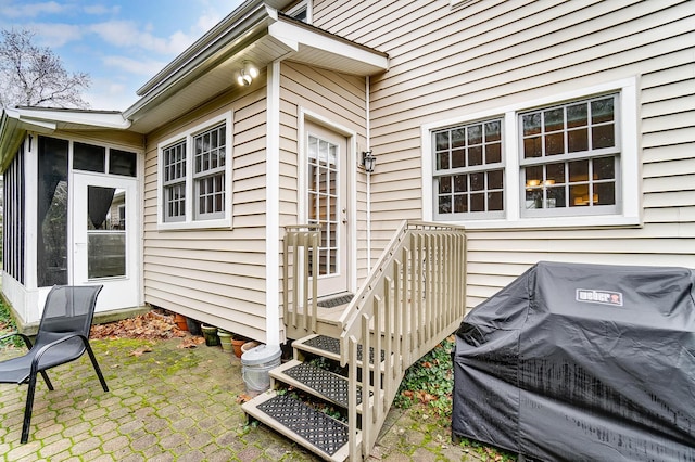 view of exterior entry featuring a patio