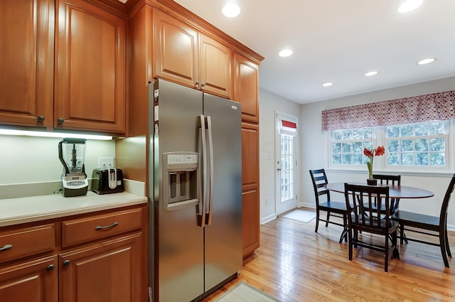 kitchen with stainless steel fridge and light wood-type flooring