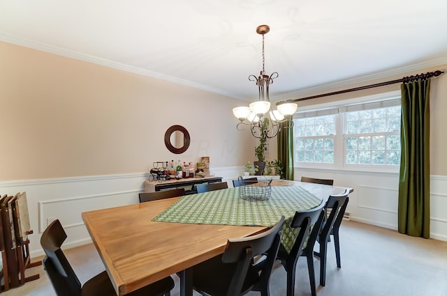 carpeted dining area featuring crown molding and a notable chandelier