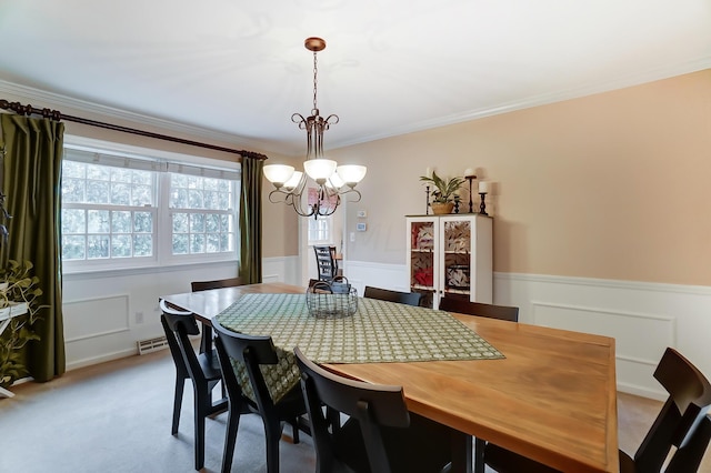 carpeted dining room with crown molding