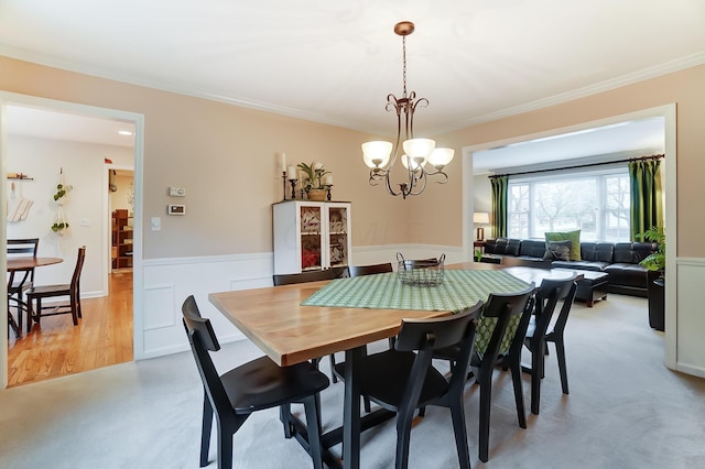 dining room featuring an inviting chandelier and crown molding