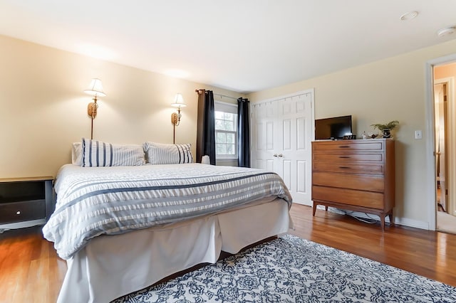 bedroom featuring wood-type flooring and a closet