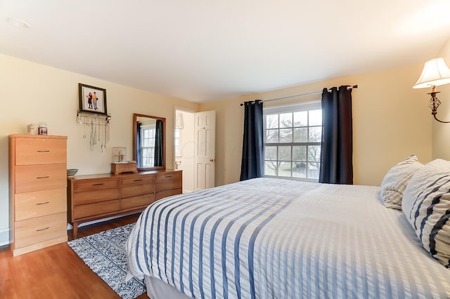 bedroom with dark wood-type flooring