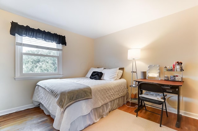 bedroom with hardwood / wood-style flooring