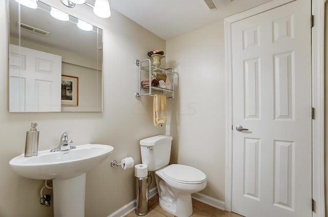 bathroom with tile patterned floors and toilet