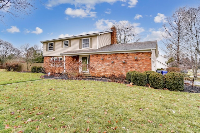 rear view of property featuring a yard