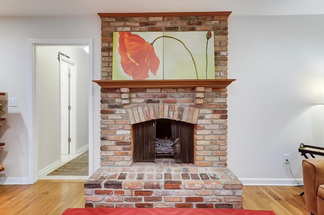 details featuring a brick fireplace and hardwood / wood-style flooring