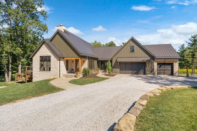 modern farmhouse featuring a garage and a front lawn