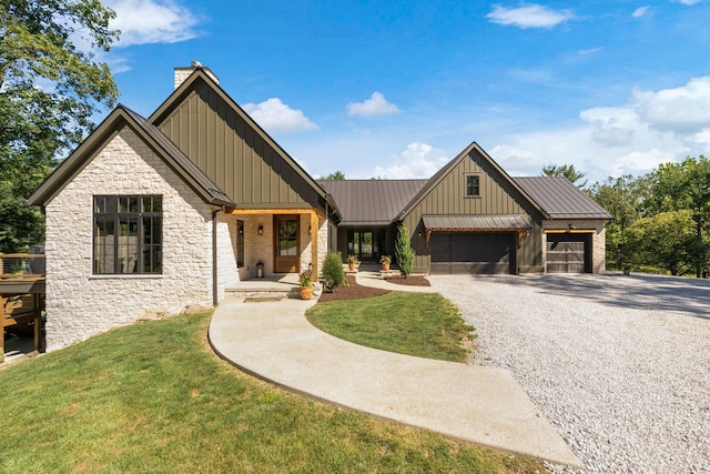 modern farmhouse style home featuring a front yard and a garage