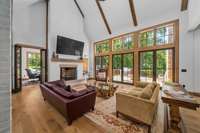 living room featuring french doors, high vaulted ceiling, and a wealth of natural light