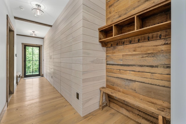 mudroom with wooden walls and light hardwood / wood-style flooring