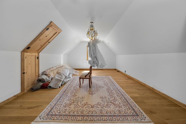 additional living space with vaulted ceiling and light wood-type flooring