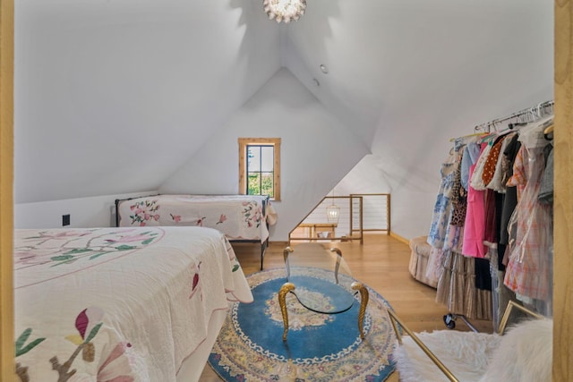 bedroom featuring light hardwood / wood-style flooring and lofted ceiling