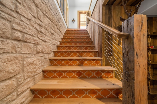 staircase with hardwood / wood-style flooring