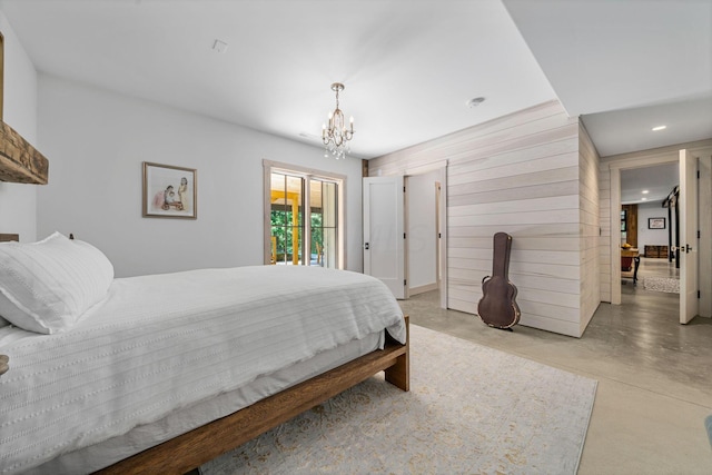 bedroom featuring access to outside, wooden walls, and a chandelier