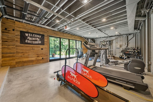 gym featuring wood walls